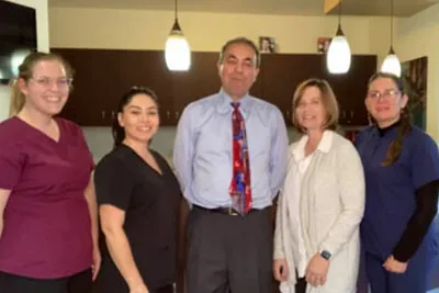 Dr. Haidari with the Clayton Dental Group staff