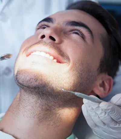 patient smiling during his dental bonding procedure at Clayton Dental Group