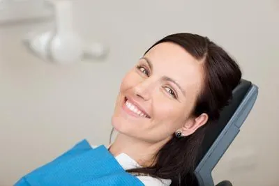 woman smiling during her first visit to Clayton Dental Group