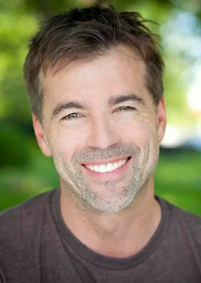 man smiling after getting dentures