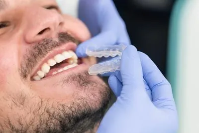 Dr. Haidari placing a patient's new Invisalign aligners