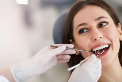 dentist cleaning a patient's teeth