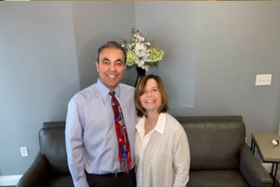 Dr. Haidari smiling with a patient