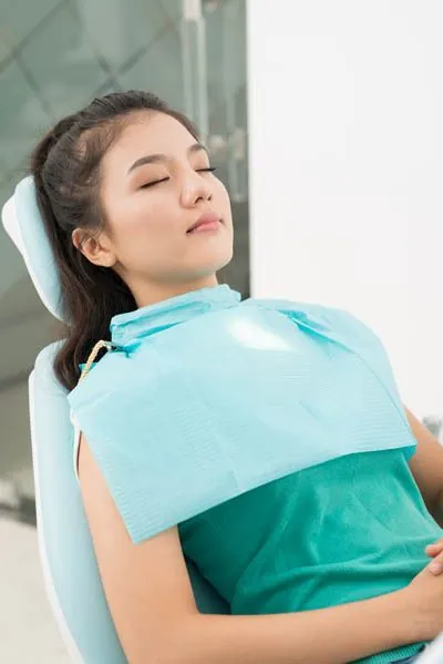 patient sleeping during her dental procedure thanks to sedation dentistry