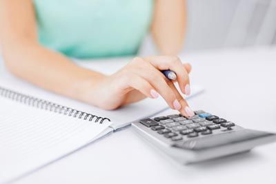 woman calculating her finances using a calculator