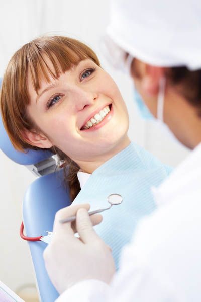 patient receiving a follow up checkup after her oral surgery procedure