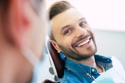 Clayton Dental Group patient smiling in the dental exam room