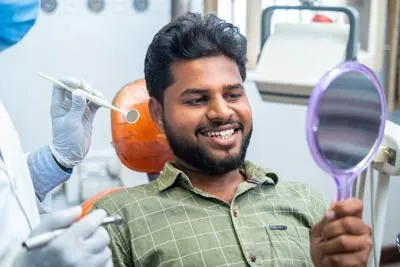 patient looking at his restored smile after periodontal treatment at Clayton Dental Group in Concord, CA