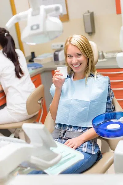 patient smiling before taking a sedative to help relax her for her dental procedure